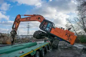 Excavator loading onto beam trailer