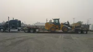 John Deere wheel loader on RGN trailer for heavy equipment transport