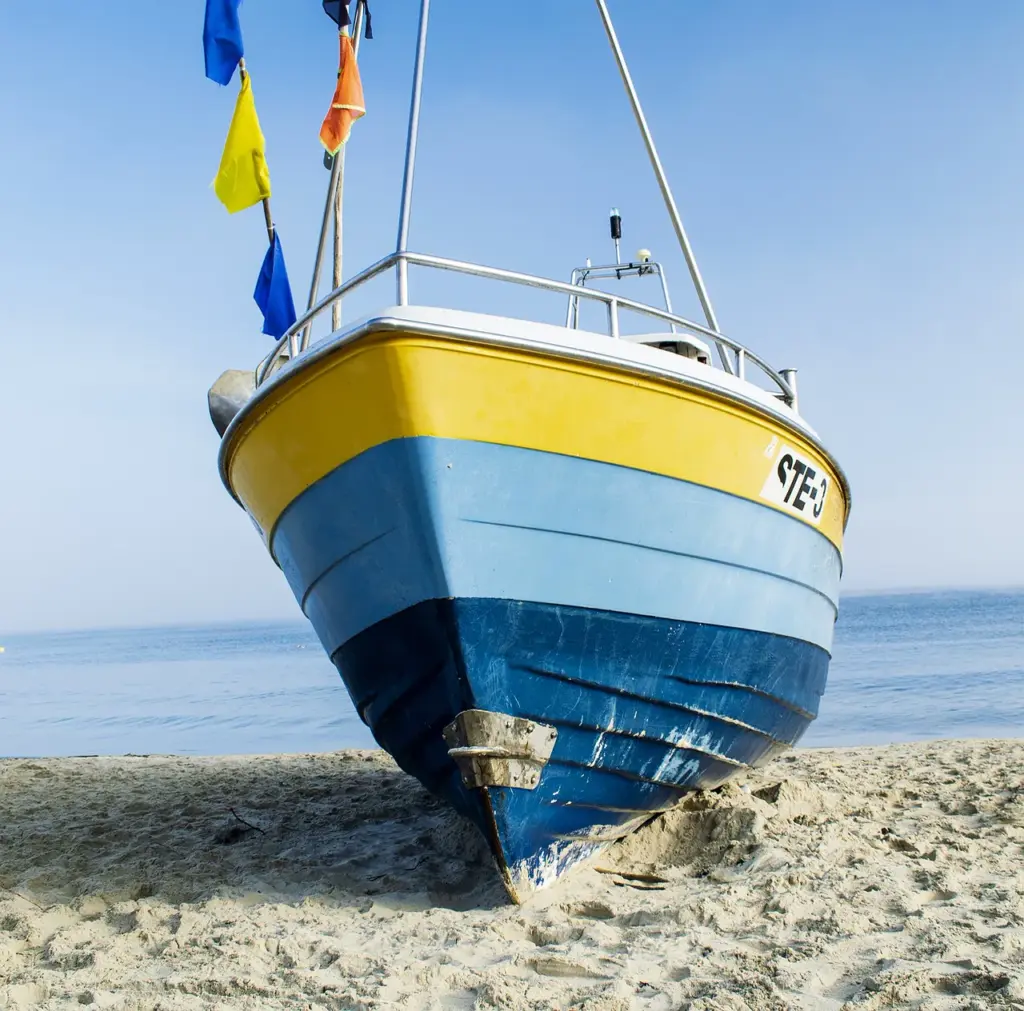 Small sailboat on beach.