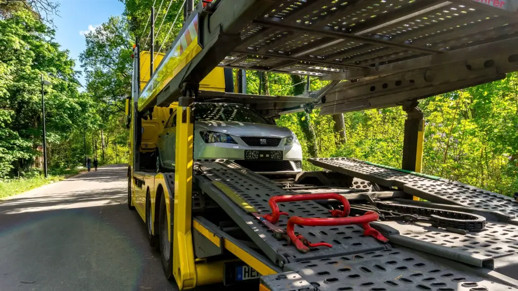 Car transport, car shipping. Car loaded in belly of double deck car hauler.